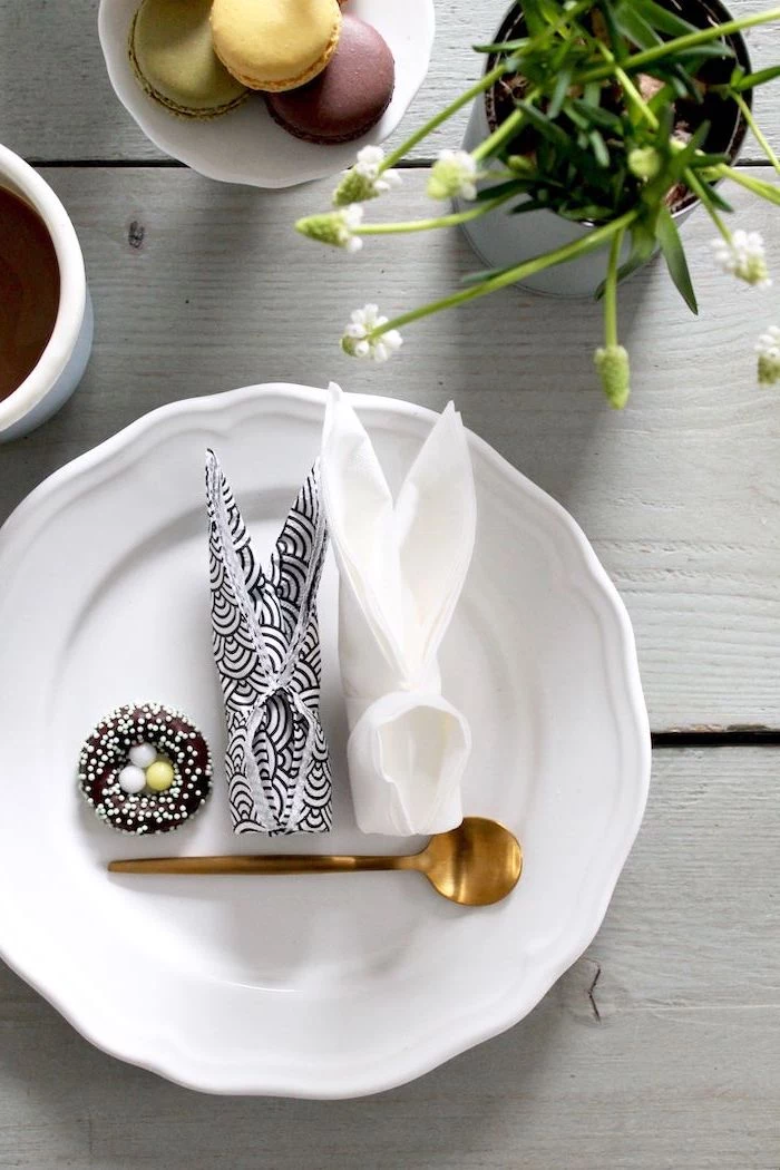 bunny shaped, black and white napkins, chocolate egg nest, brass teaspoon, napkin folding with silverware