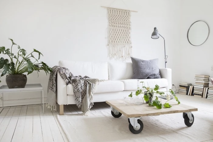 wooden table on wheels, white sofa, macrame wall hanging patterns free, grey blanket, potted plants