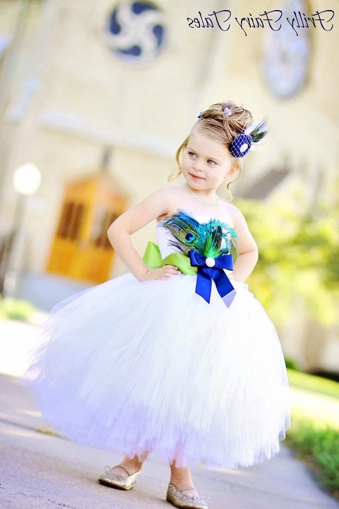 blonde hair, white tulle dress, green and blue bows, peacock feathers, girls dresses for special occasions