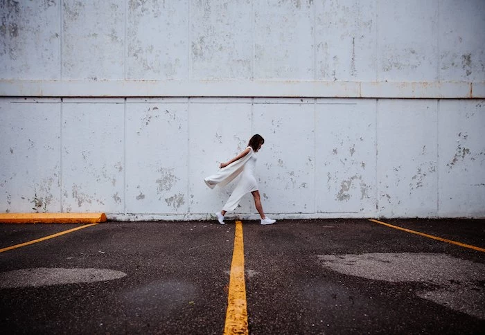 woman walking, wearing a white dress, white sneakers, tumblr computer backgrounds, white wall
