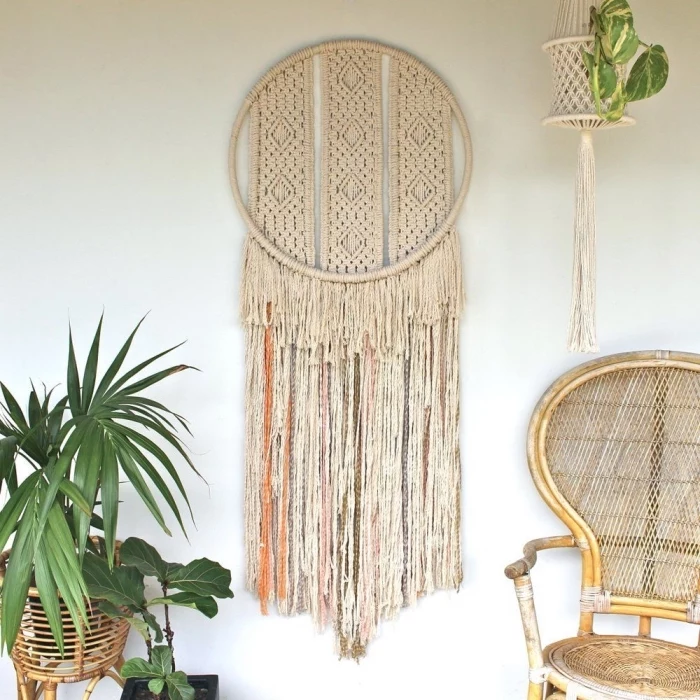 wooden chair, macrame backdrop, potted plants, plant hanger, white wall