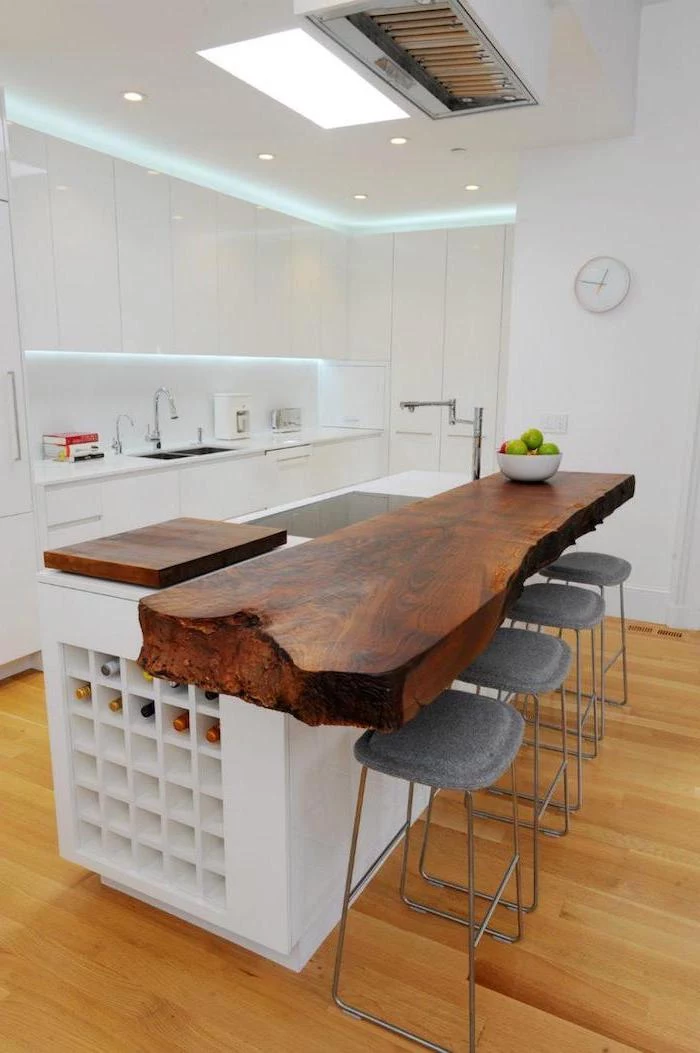 wooden countertop, grey metal bar stools, kitchen island with seating for 4, wooden floor, white cabinets