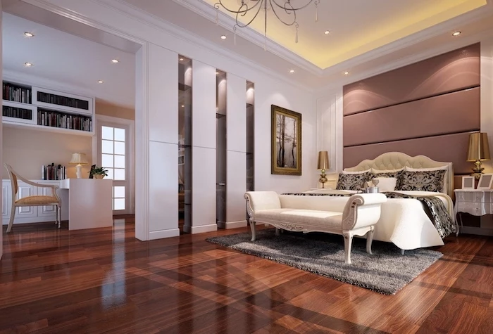 dark wooden floor, white walls, white ottoman, leather headboard, master bedroom wall decor, grey carpet