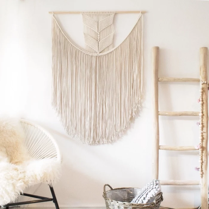 wooden ladder, macrame wall hanging knots, white chair, furry blanket, white wall, wooden basket
