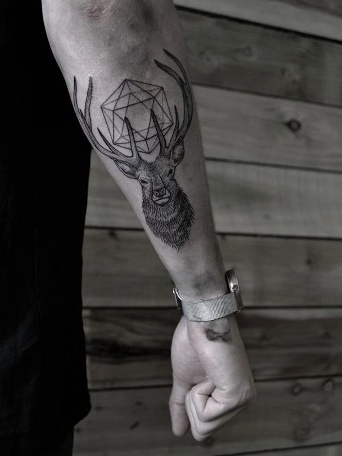 geometrical deer, forearm tattoo, wooden wall, cool simple tattoos, black shirt