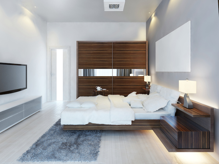 wooden wardrobe, grey accent wall, white walls, master bedroom wall decor, grey carpet, floating bed frame