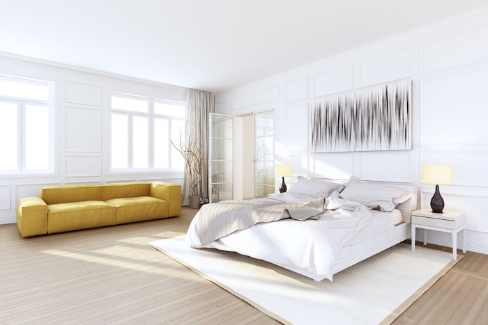 yellow leather sofa, wooden floor, master bedroom wall decor, white walls, white carpet, wooden night stand