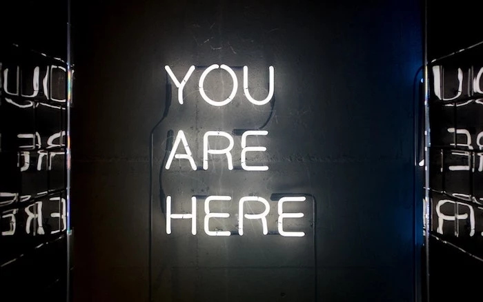 you are here, neon sign, black background, tumblr wallpaper quotes