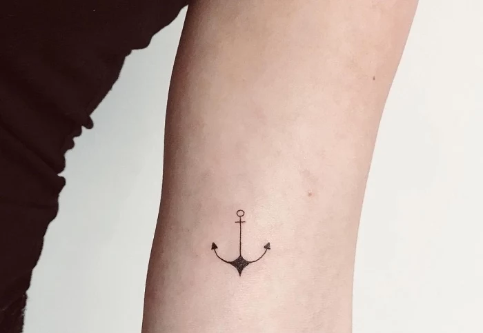 anchor tattoo, inside the arm, black top, simple tattoo, white background