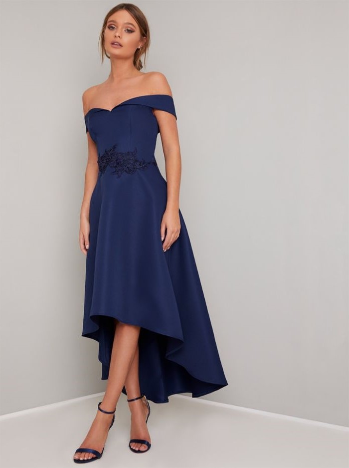 asymmetrical blue dress, mother of the bride dresses, blue sandals, blonde hair, low updo, off the shoulder neckline