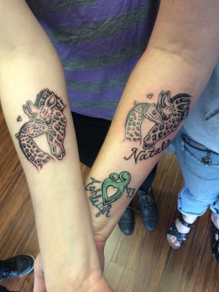 mother and baby giraffe, matching mother daughter tattoos, forearm tattoos, wooden floor