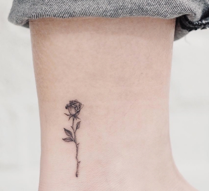 black rose, ankle tattoo, inner bicep tattoo, blue jeans, white background