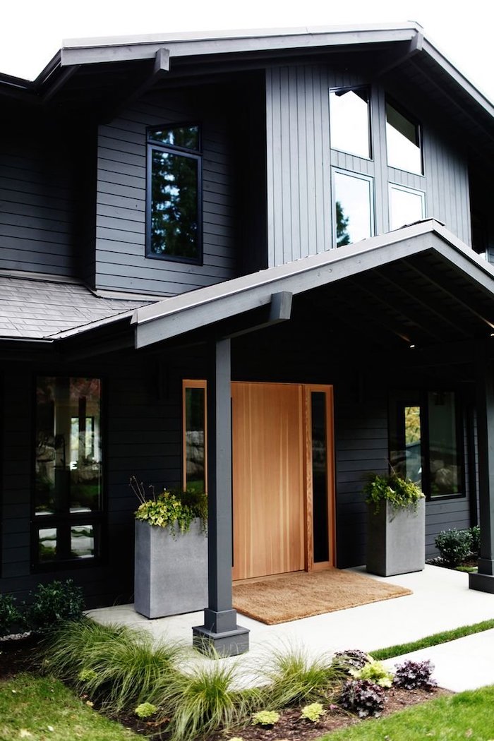 dark wooden house, large door, metal columns, potted plants, front porch decorating ideas