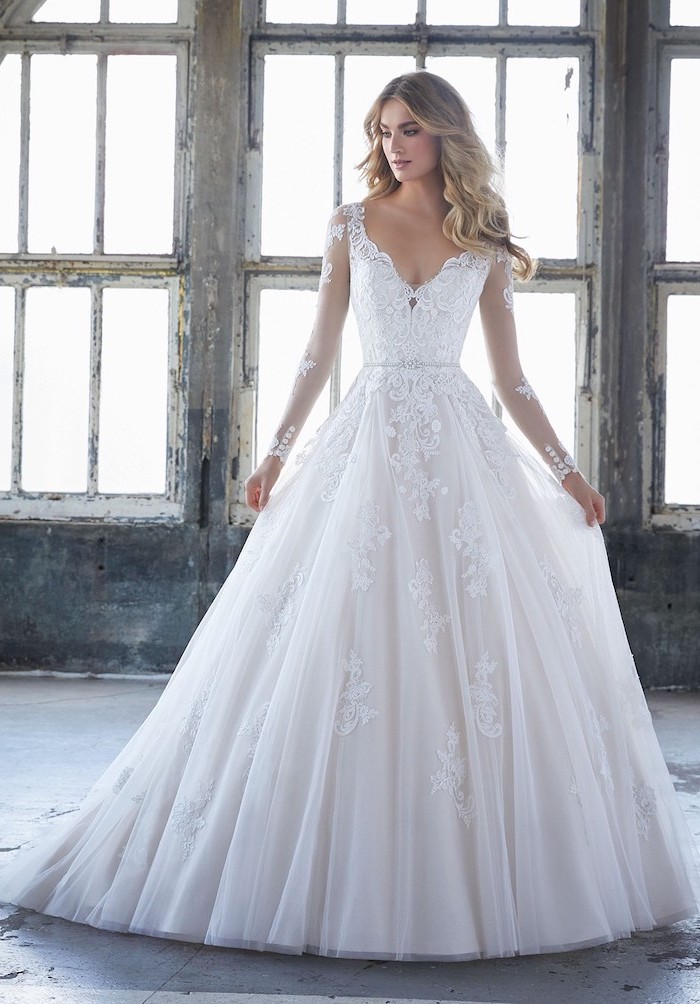 large white dresses, made of lace and tulle, blonde long wavy hair, long sleeve wedding dresses
