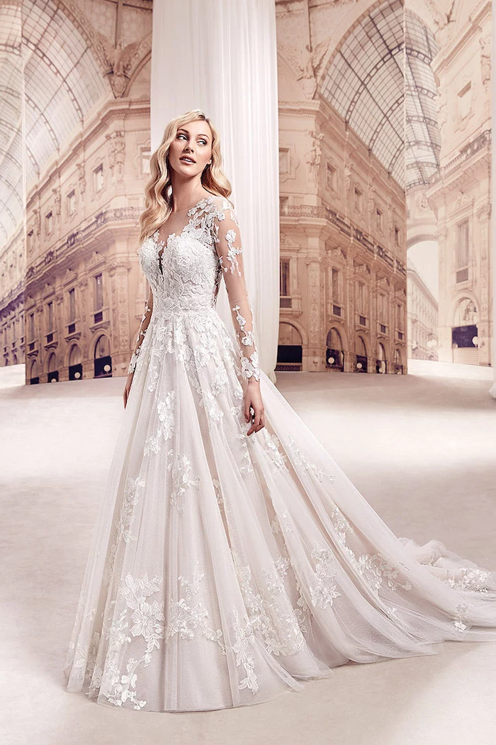 long white dress, made of chiffon and lace, long blonde wavy hair, long lace sleeves, beaded wedding dresses