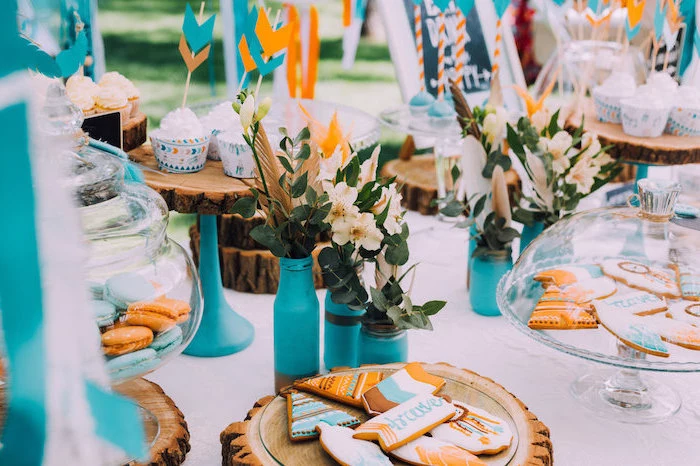 orange and blue, rustic decor, wooden cake stands, macaroons in a jar, flower bouquets, birthday party themes
