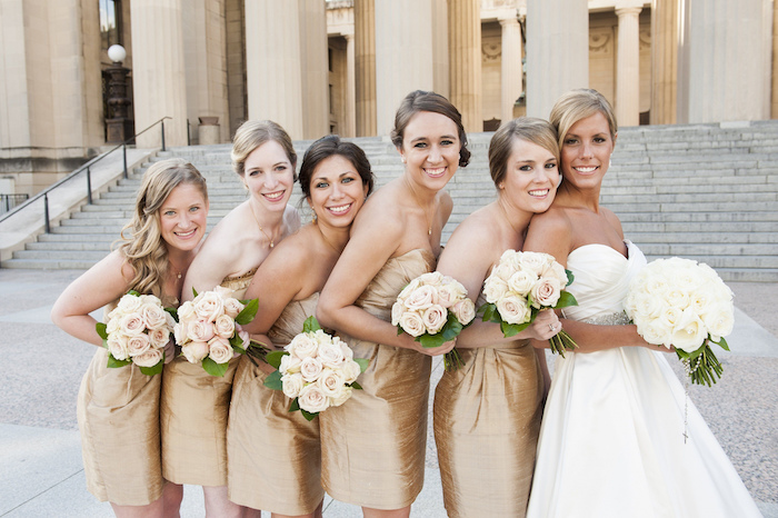 white flower bouquets, short gold, strapless dresses, rose gold bridesmaid dresses, bride at the front
