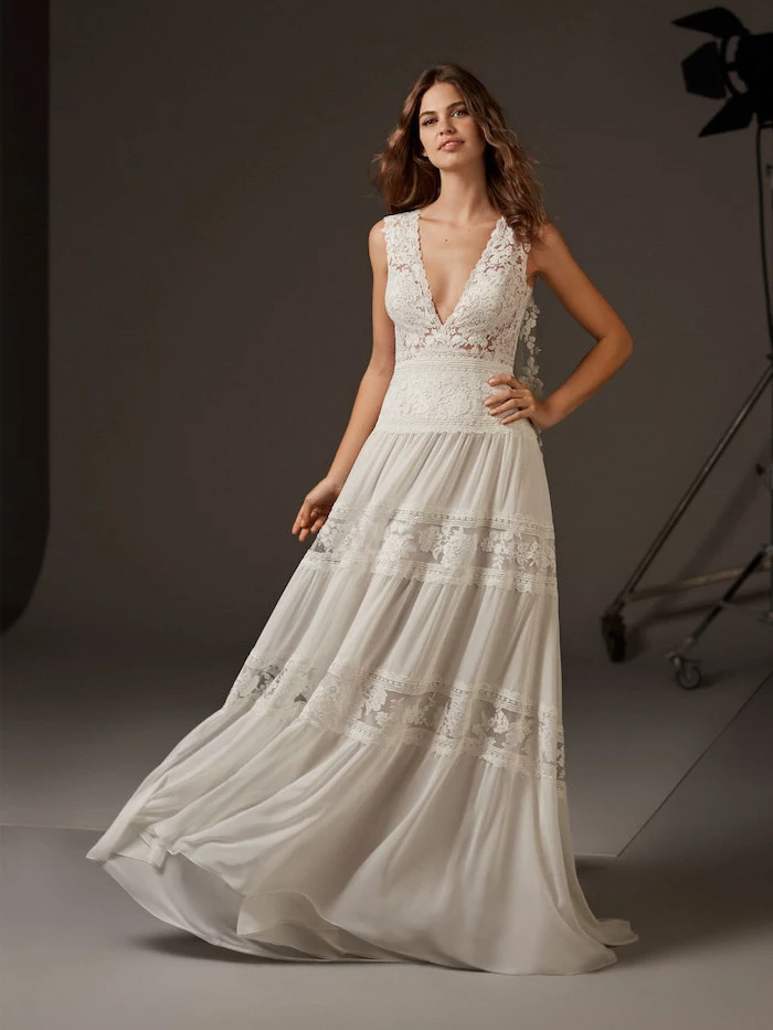 long brown wavy hair, boho beach wedding dress, made of lace and chiffon, plunging v neckline