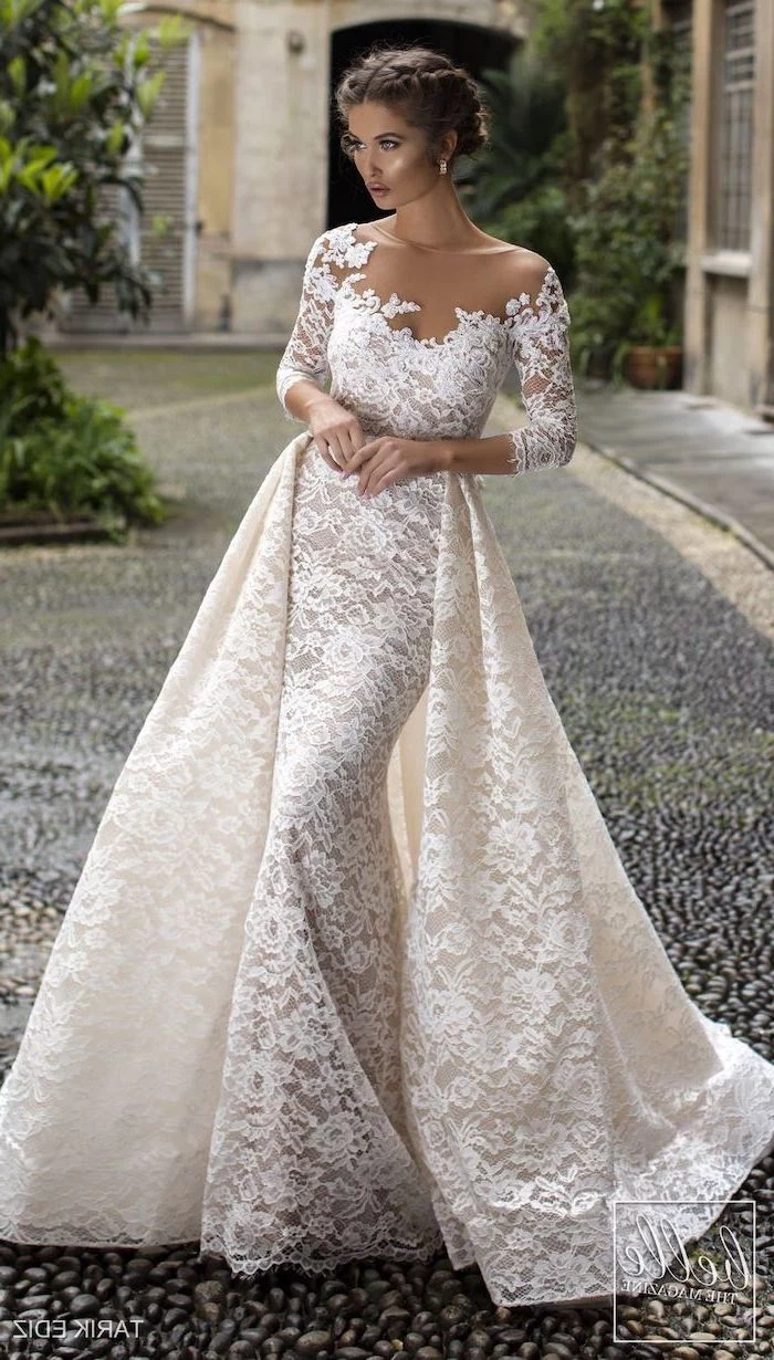 flowy wedding dress, braided brown hair, in a low updo, lace dress, lace train, off shoulder, long sleeves