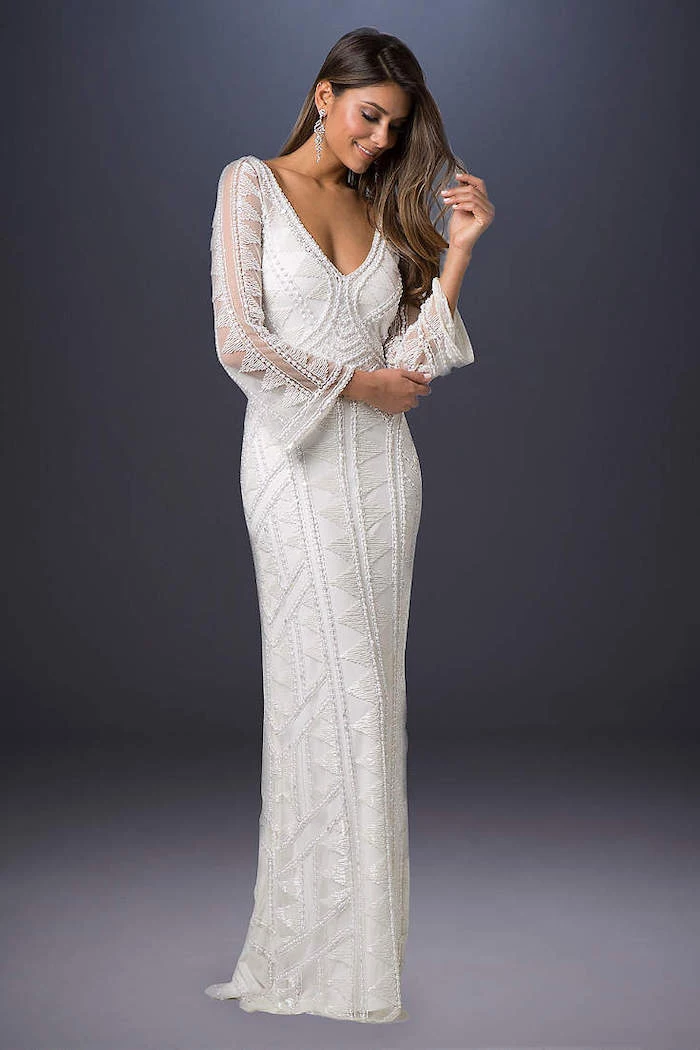 grey background, wedding dresses with sleeves, v neckline, long lace dress, long brown wavy hair