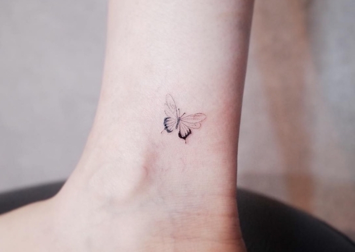 butterfly tattoo, inner bicep tattoo, ankle tattoo, blurred background