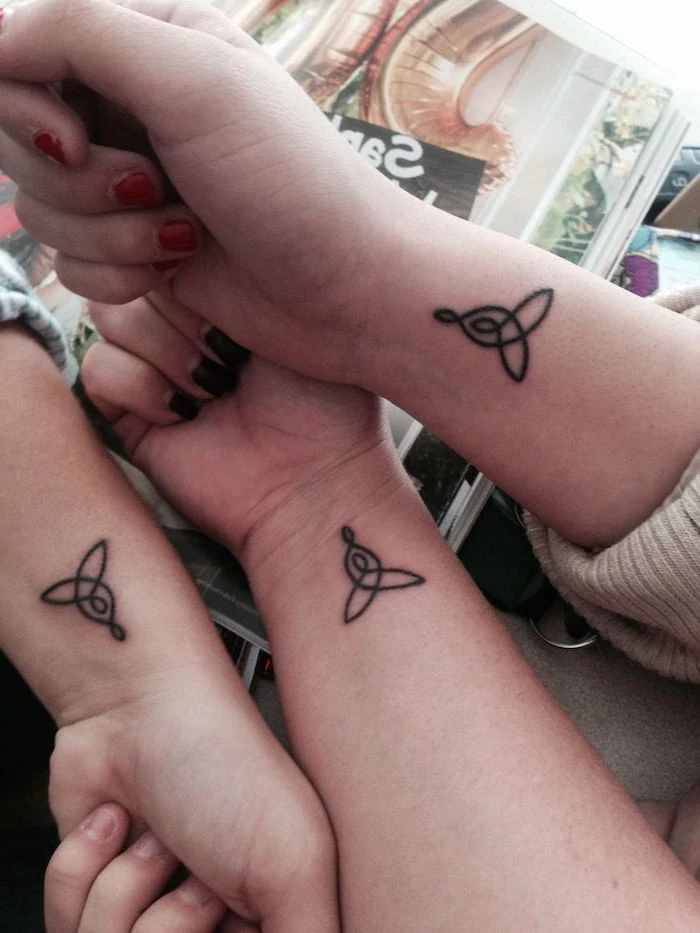 mother daughter tattoo ideas, celtic symbols, wrist tattoos, three hands