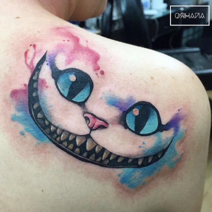 cheshire cat, watercolor feather tattoo, shoulder tattoo, alice in wonderland inspired