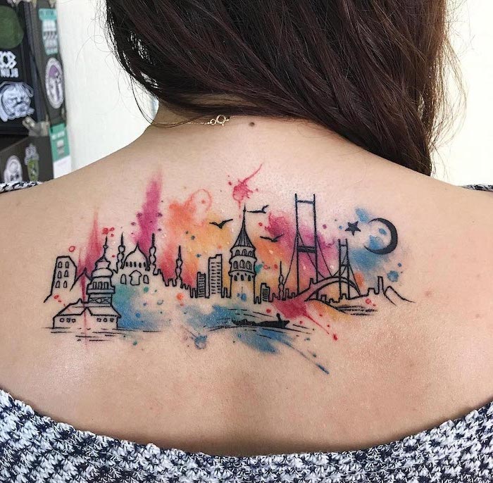 orchid flower tattoo, city skyline, watercolor back tattoo, brown hair, black and white sweater