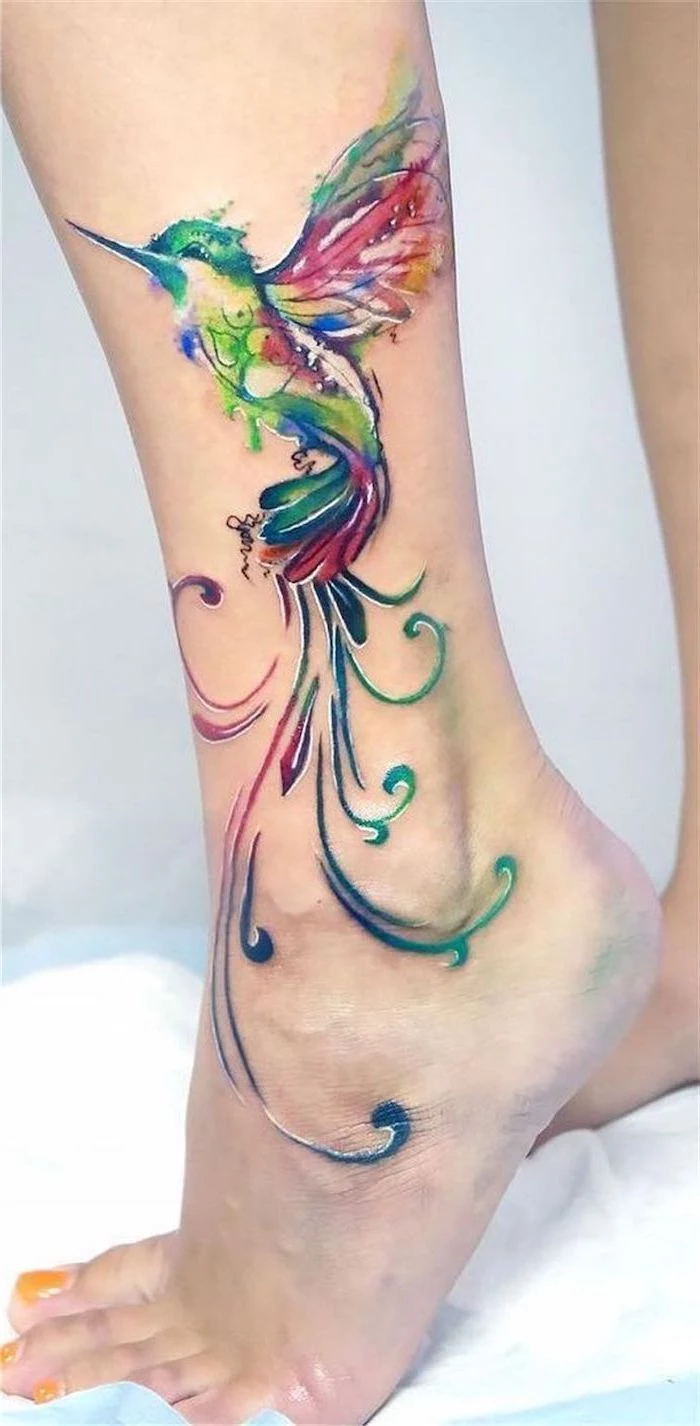 floral tattoos, colourful collibri, side of leg tattoo, yellow nail polish