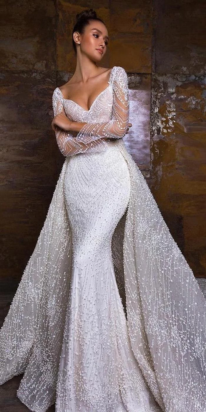 crystals on tulle, long sleeve lace mermaid wedding dress, brown hair, in a bun, v neckline