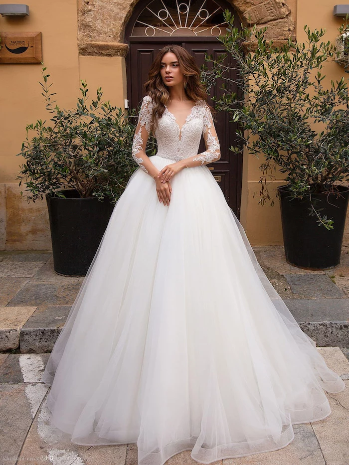 long brown wavy hair, white dress, made of tulle and lace, wedding dresses with sleeves
