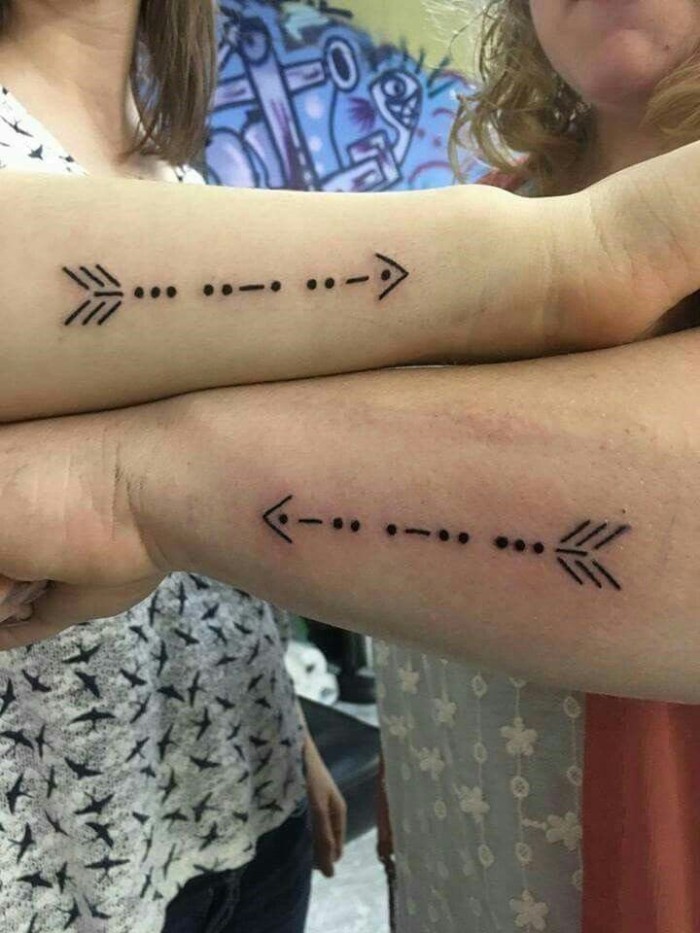 arrow made of lines and dots, side arm tattoos, matching tattoos, grey blouses