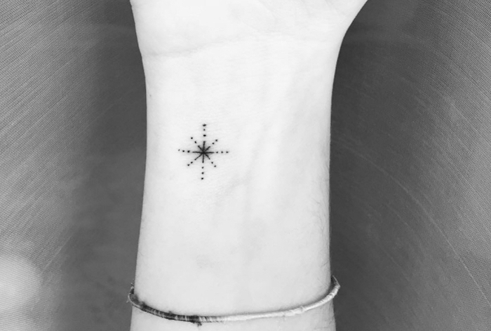 dotted star, wrist tattoo, grey background, key tattoos, black and white photo