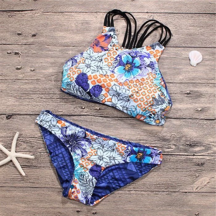 two piece, cute bathing suits for girls, floral print, black straps, wooden background