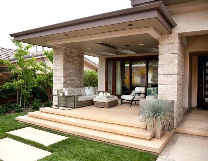 wooden garden furniture, front porch ideas, tiled pathway, brick columns, white cushions
