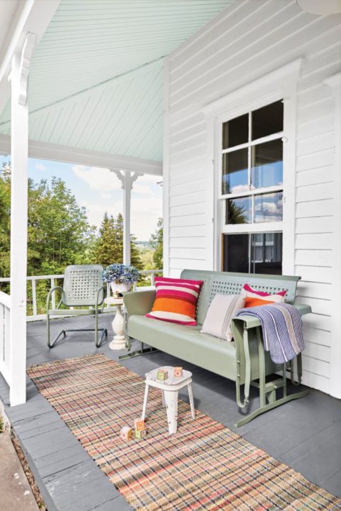 colourful rug, screened in porch designs, green metal sofa and chair, colourful throw pillows