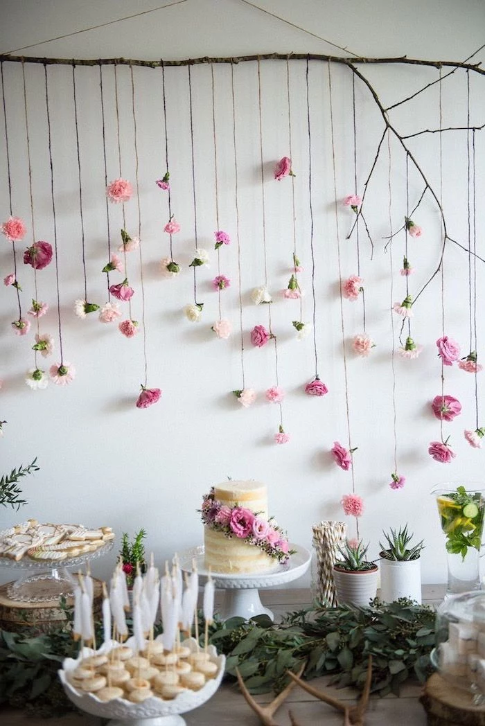 fun birthday ideas, hanging flowers, from a tree branch, white cake stands, cake pops, greenery table runner