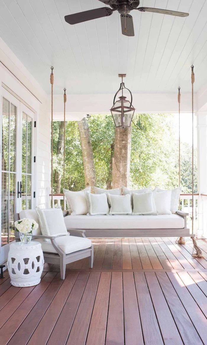 wooden swing, white cushions and throw pillows, screened in porch designs, wooden floor
