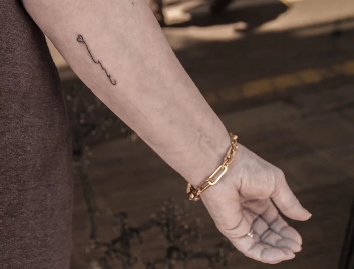 small heart, forearm tattoo, golden bracelet, grey shirt, tiny tattoos