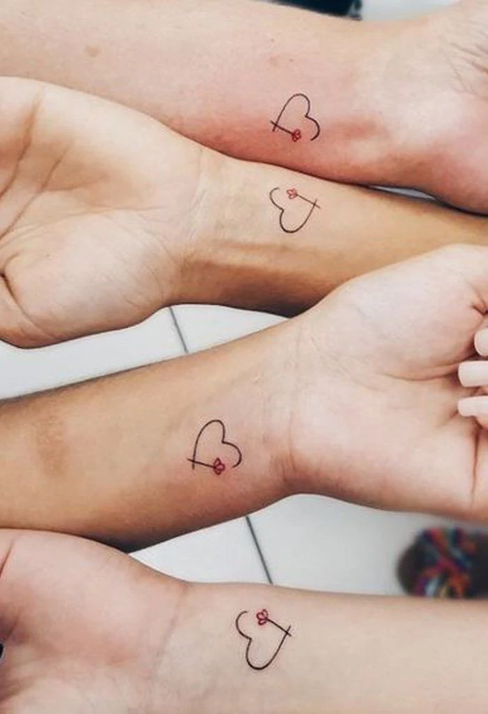 best friend tattoo ideas, hearts and flowers, four hands next to each other, wrist tattoos