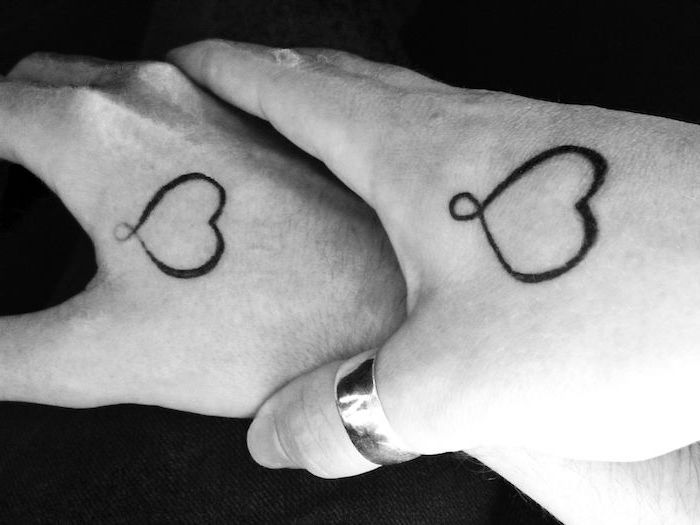 heart outlines, black and white photo, mother and daughter matching tattoos, hand tattoos