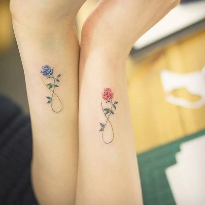 infinity symbols, made up of roses, pink and blue, best friend tattoo ideas side arm tattoos