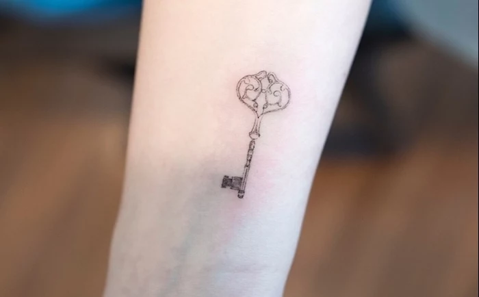vintage key, tattoo placement ideas, wrist tattoo, blurred background