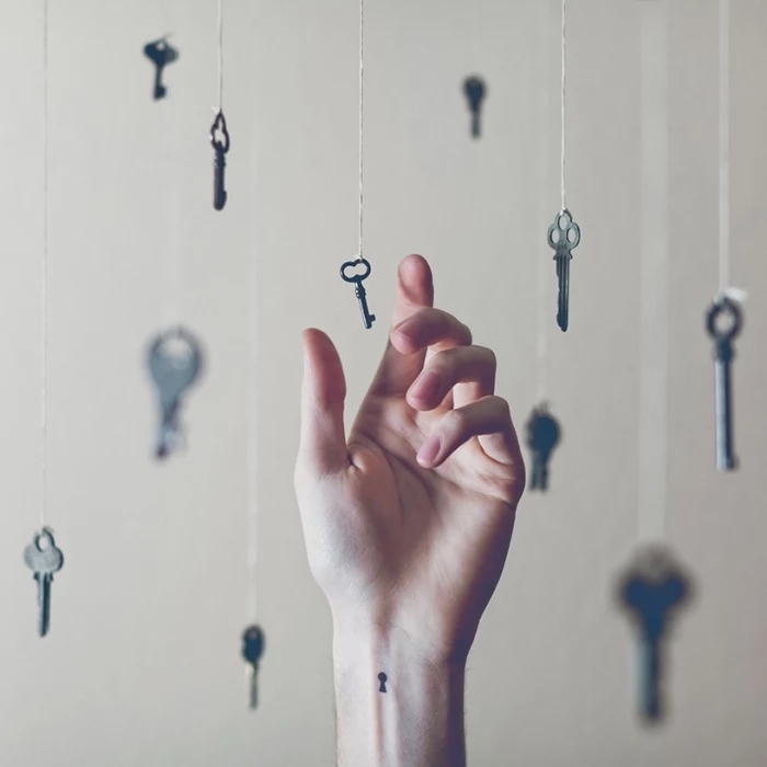 keys hanging, on white strands, tattoo placement ideas, keyhole wrist tattoo