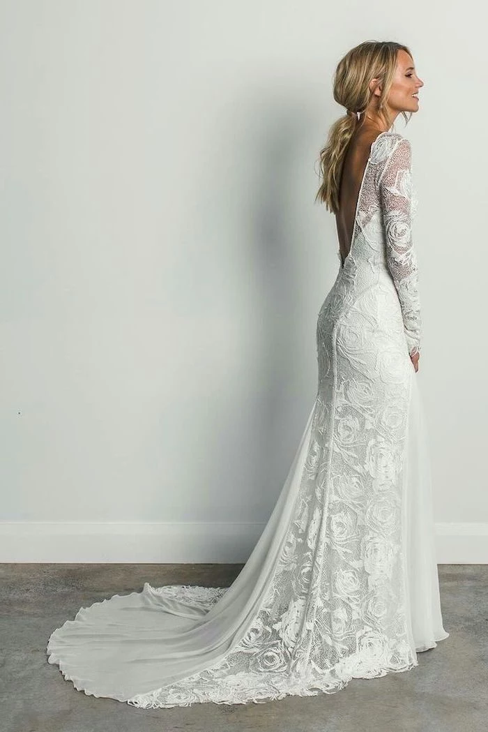 long blonde hair, in a ponytail, long train, lace dress, informal wedding dresses, open back, long sleeves