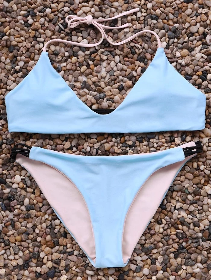 light blue, light pink, two piece, kids bathing suits, on top of rocks