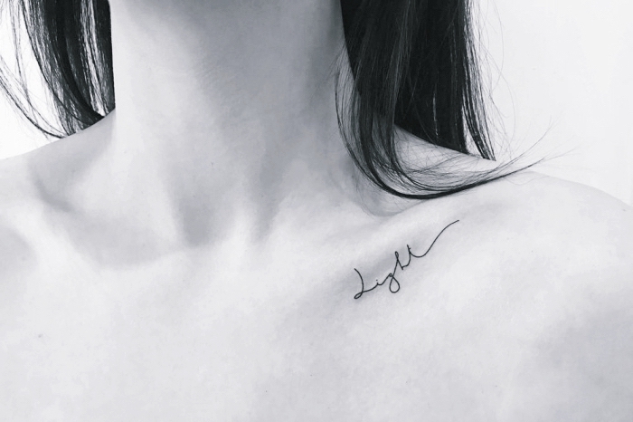 light collarbone tattoo, best places to get a tattoo, black hair, black and white photo