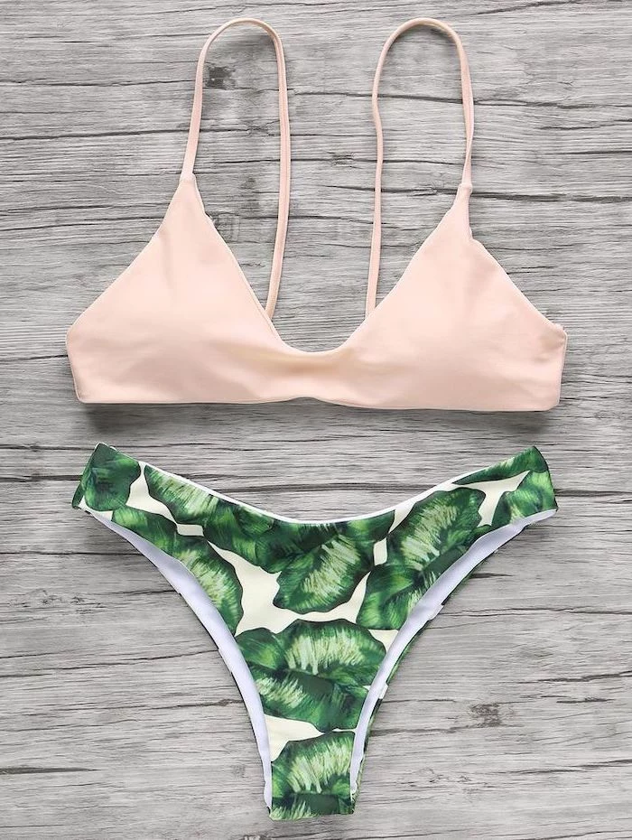 toddler mermaid swimsuit, light pink top, green leaves print, high waisted bottom, wooden background