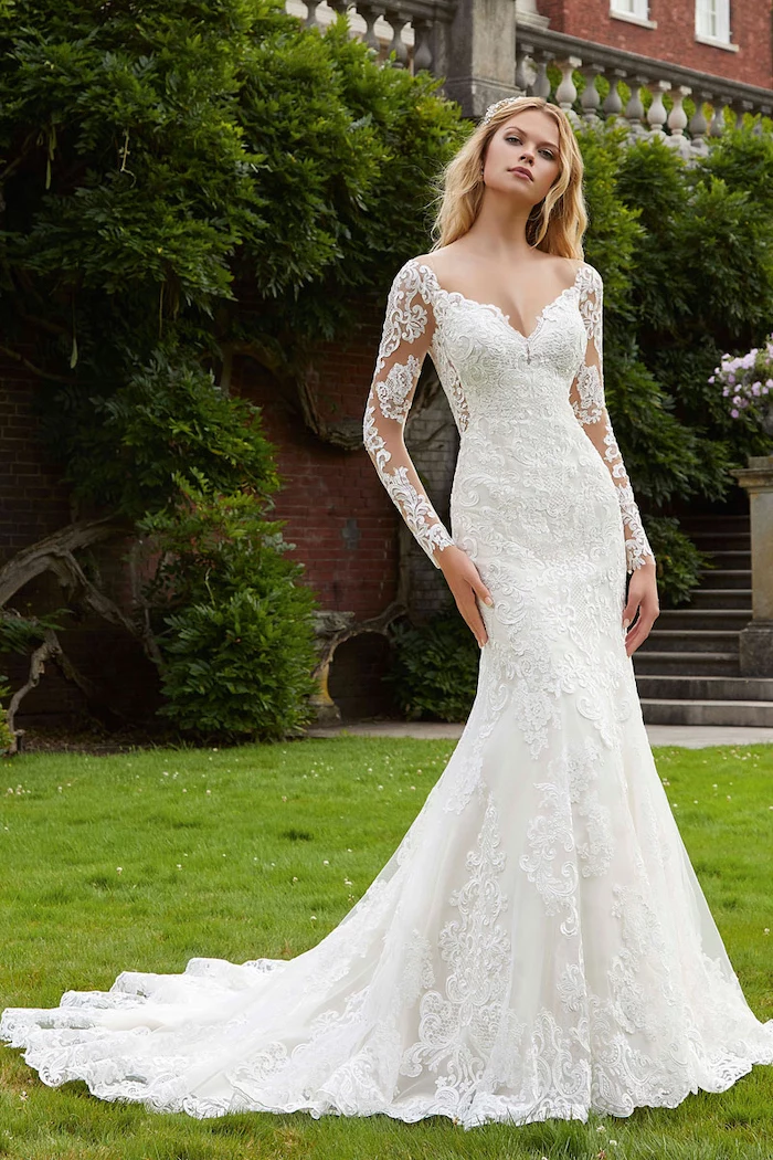 long blonde wavy hair, lace dress, long train, v neckline, fit and flare wedding dress