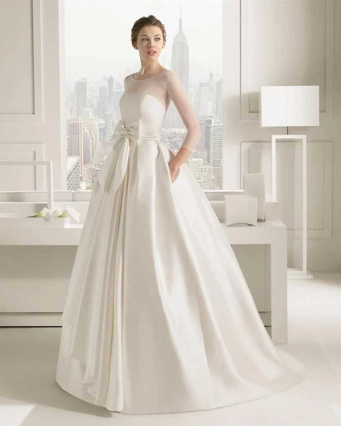 empire state building, satin wedding dresses, brown hair, in a low updo, white furniture